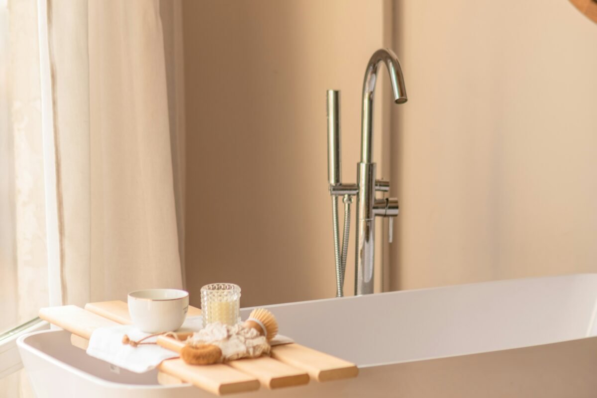 White bathtub beside a window