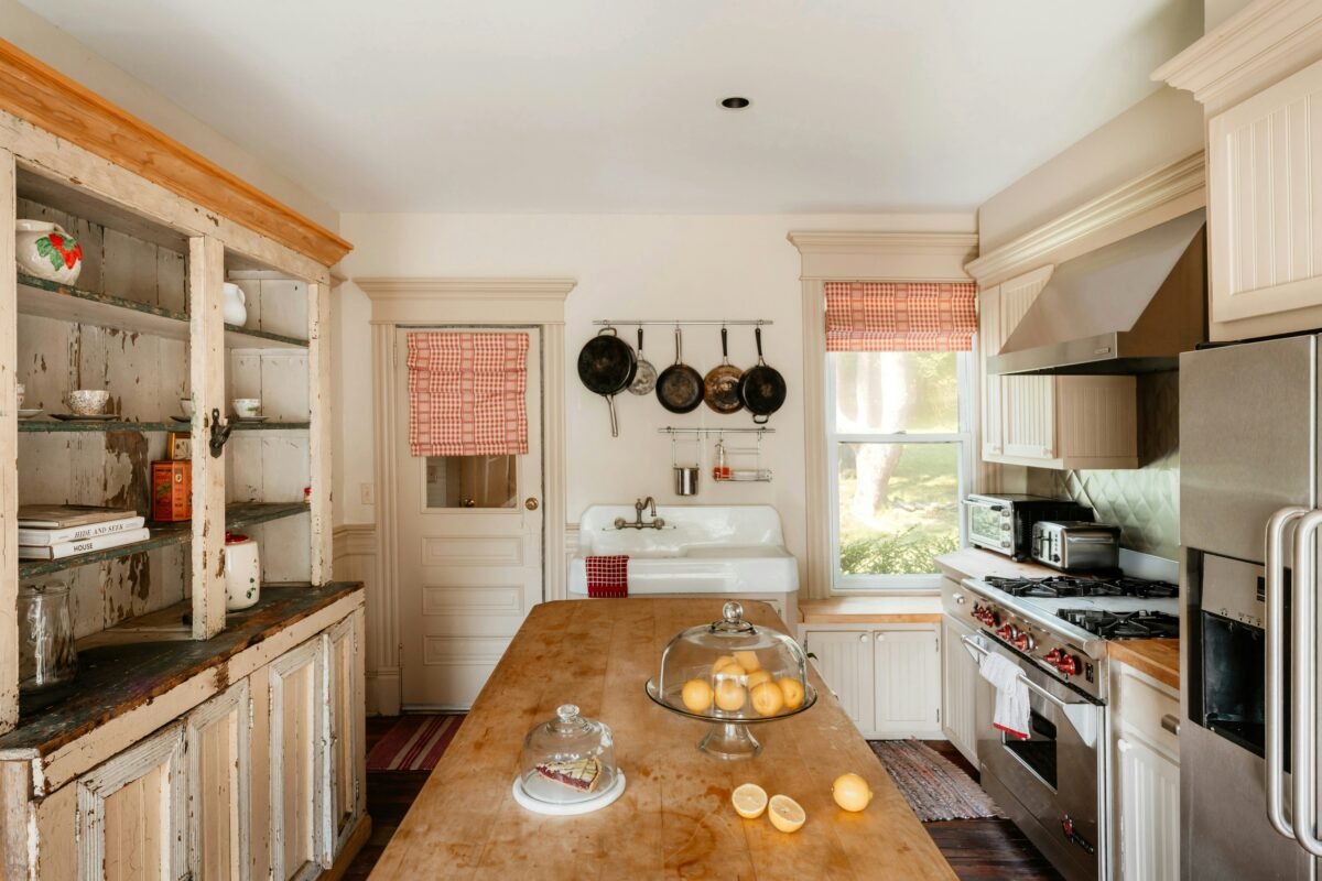 Light-filled farmhouse kitchen with butcher-block worktops and a window seat